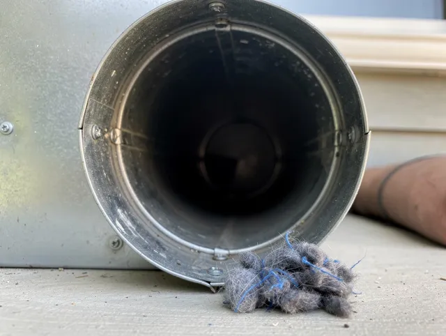 North Haven Dryer Vent Cleaning technician using specialized equipment to clear severe dryer vent blockage in North Haven